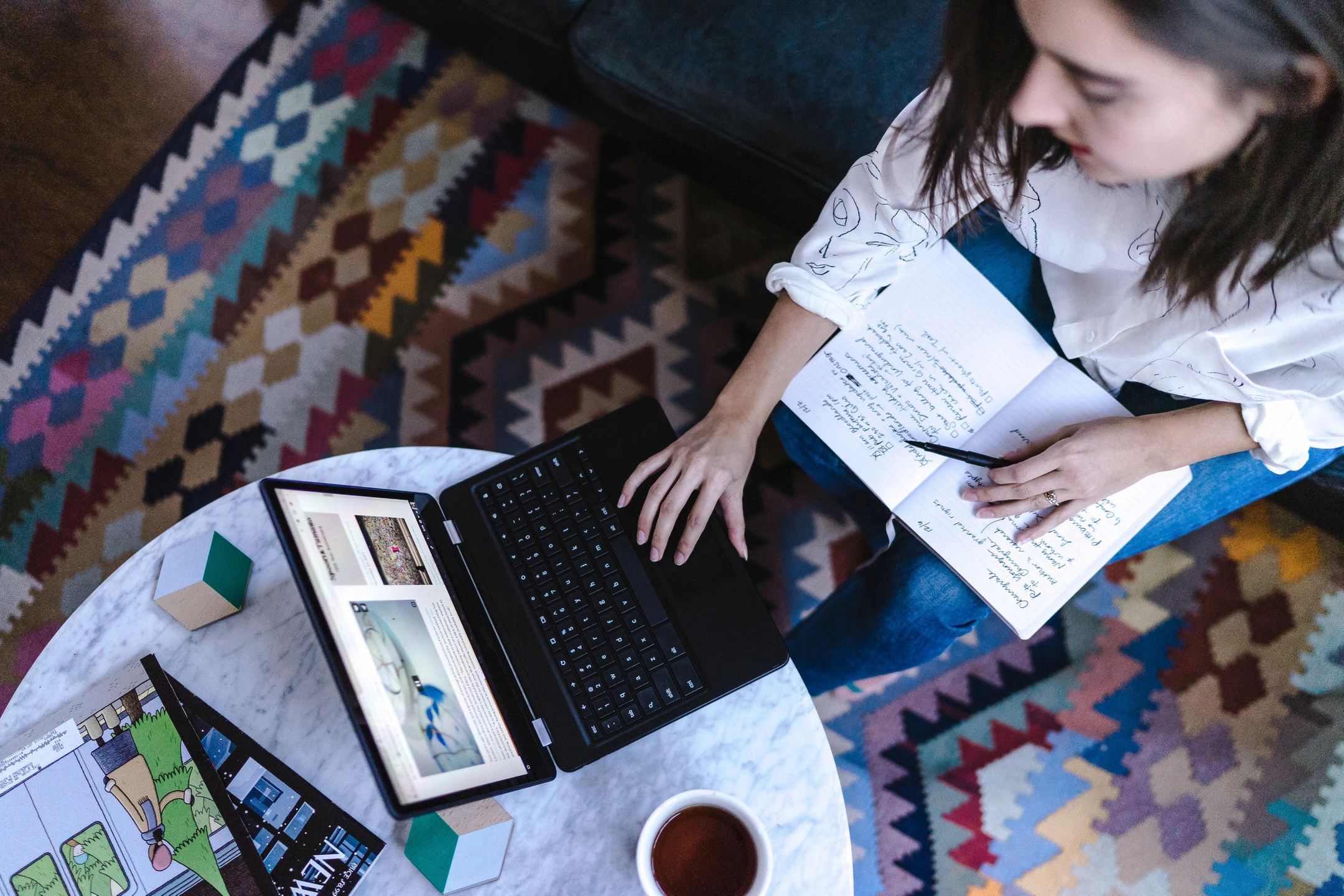 woman on computer and taking notes