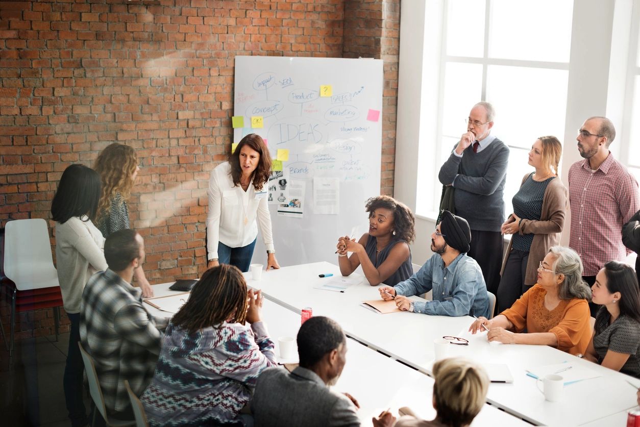 group of workers strategizing together